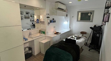 Elegant treatment room at Innior Ltd, Teddington, England, GB, featuring a massage table and soothing decor.