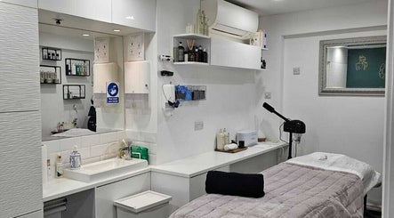 Serene spa treatment room at Innior Ltd, Teddington, England, GB, featuring a modern decor and tranquil ambiance.