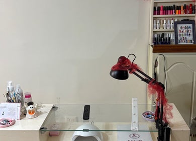 Manicure station at Annasofia Nails, Prados De Santa Rosa, Nuevo León, MX. Nail polish and tools are displayed.