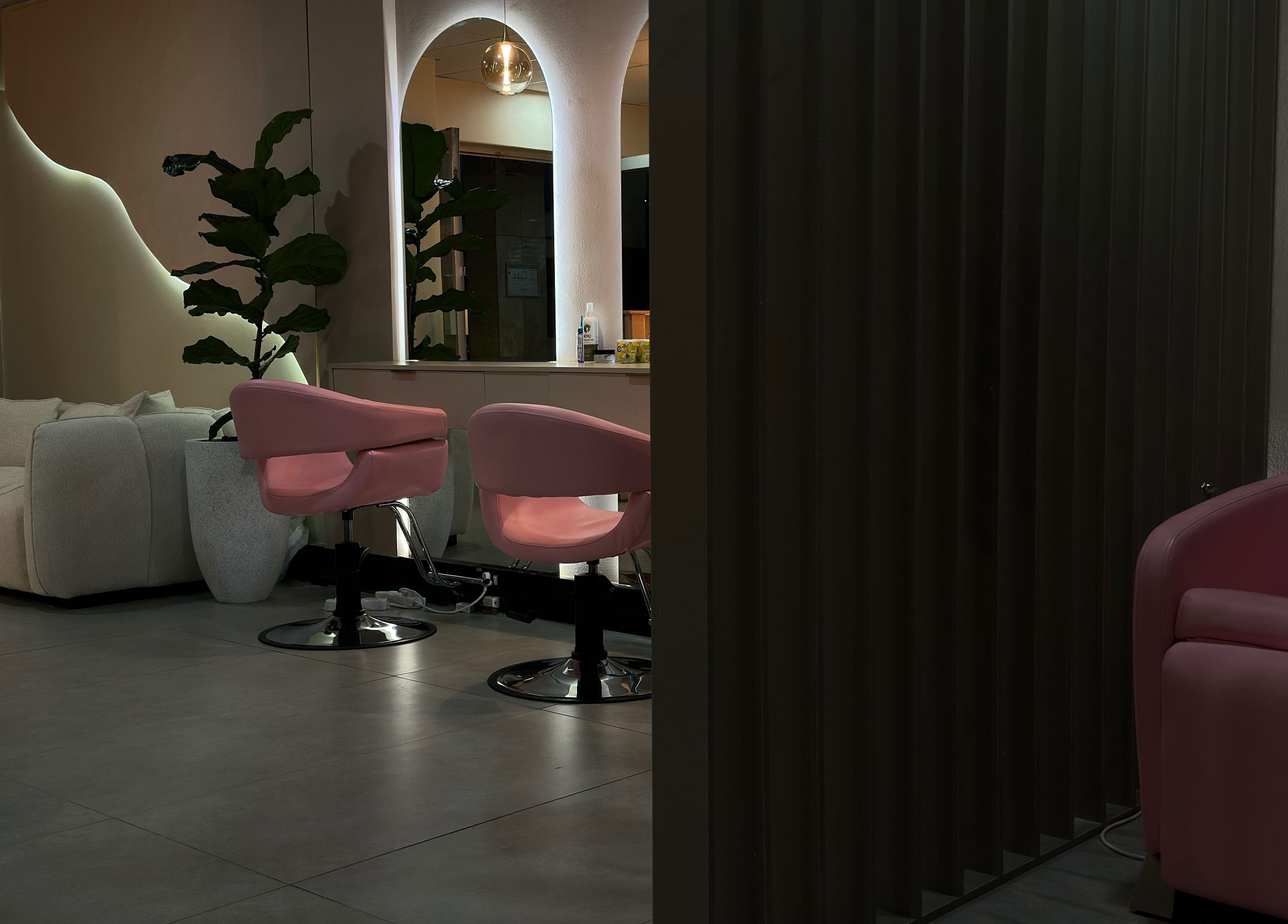 Elegant interior of Londie London Hair Studio with plush seating in Sandton, Gauteng, ZA.