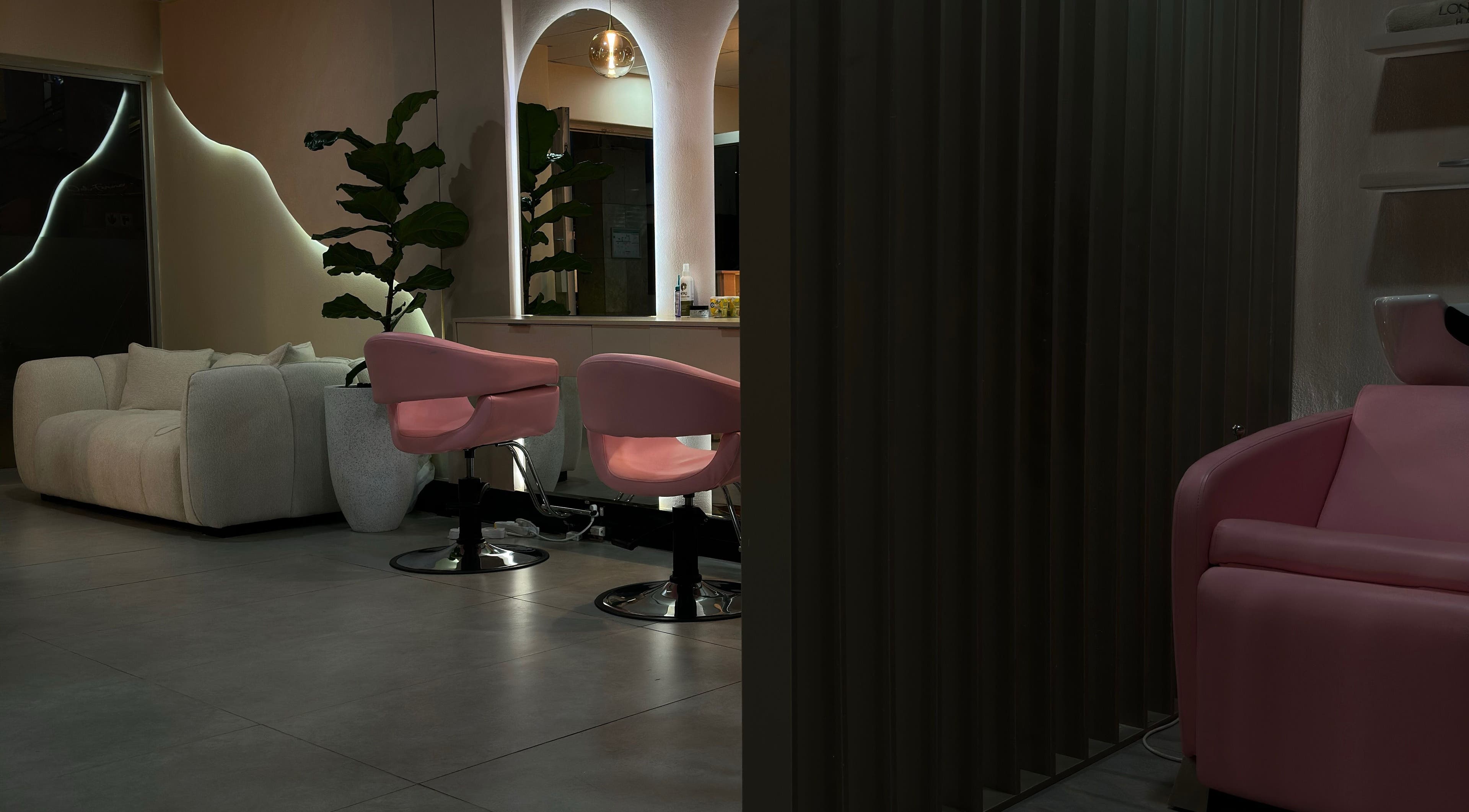 Elegant interior of Londie London Hair Studio with plush seating in Sandton, Gauteng, ZA.