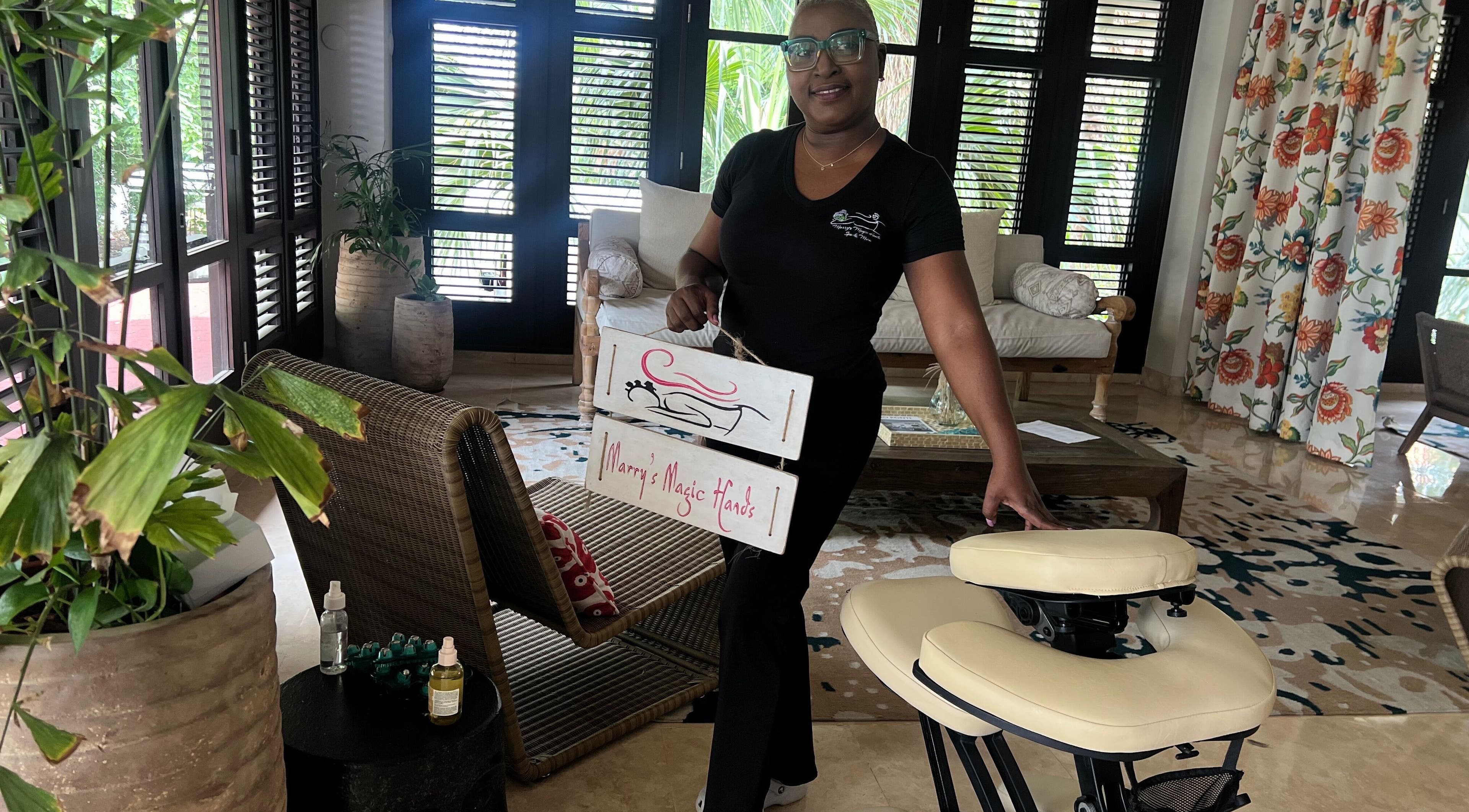 Relaxing atmosphere at Marrys Magic Hands, Willemstad, CW with massage chair and smiling host.