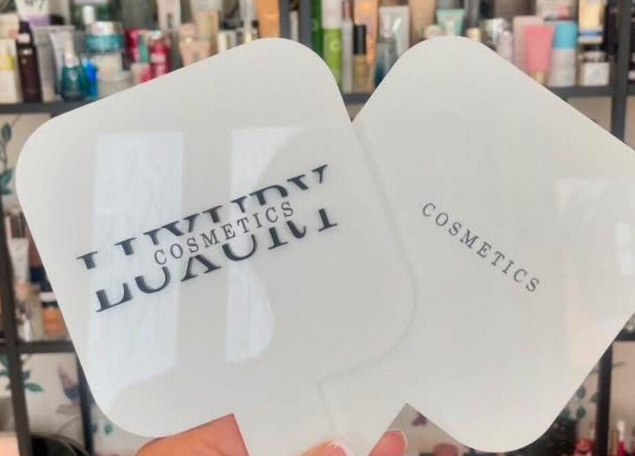 Hand holding LuxuryCosmetics mirrors in South Woodham Ferrers, England, GB beauty display.