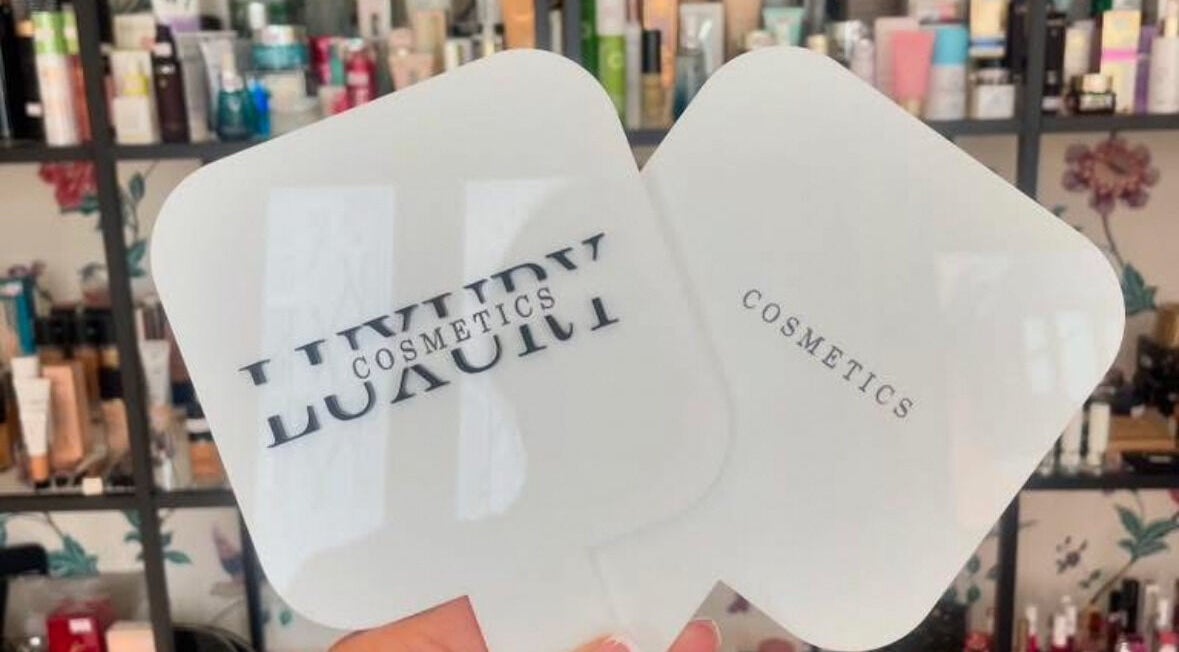 Hand holding LuxuryCosmetics mirrors in South Woodham Ferrers, England, GB beauty display.
