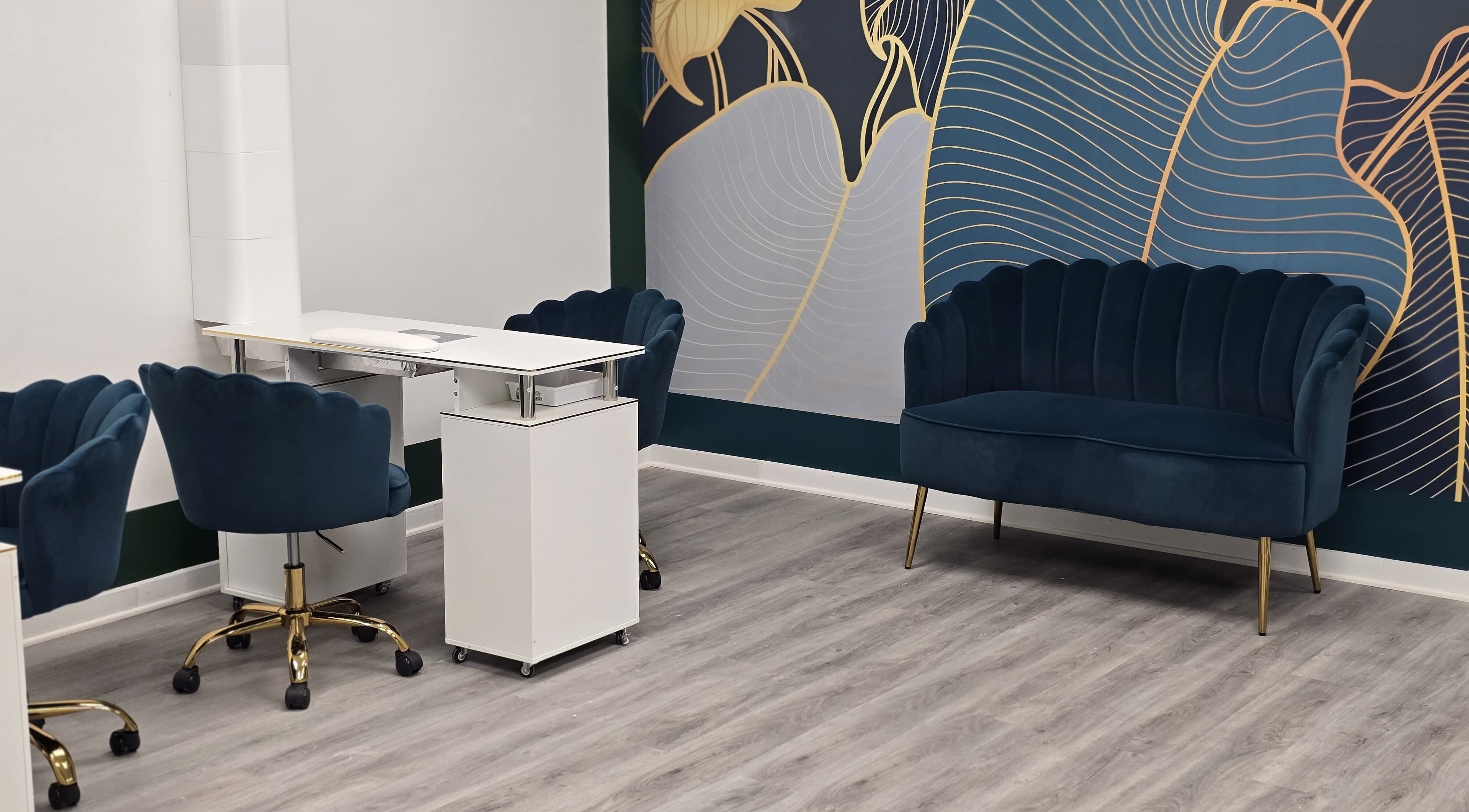 Stylish nail studio at Milenka Nails in Nags Head, North Carolina, US with modern navy seating and decor.