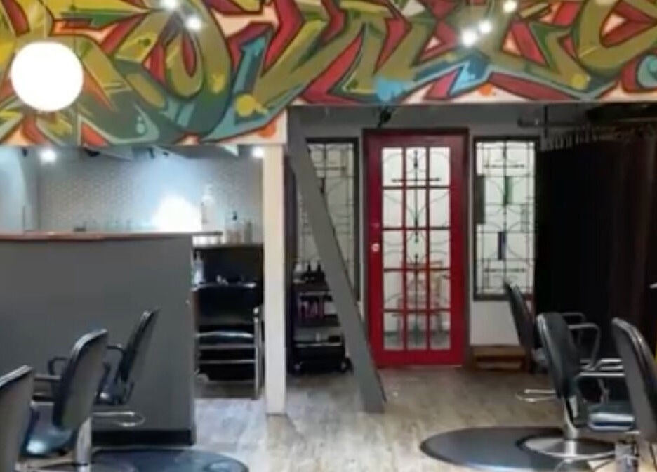 Interior of Red Square Salon in Vancouver, BC, CA featuring vibrant graffiti art and salon chairs.
