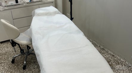 Treatment room at Flawless Society, Carisbrook, Victoria, AU with a massage bed and white linens.