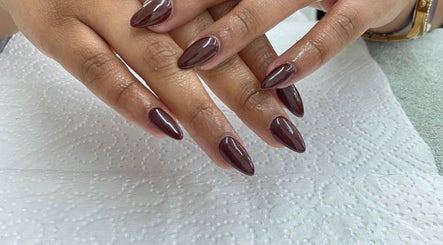 Elegant burgundy manicure at Nails By Fila, Durban, Kwazulu-natal, ZA showcasing sleek, polished nails.