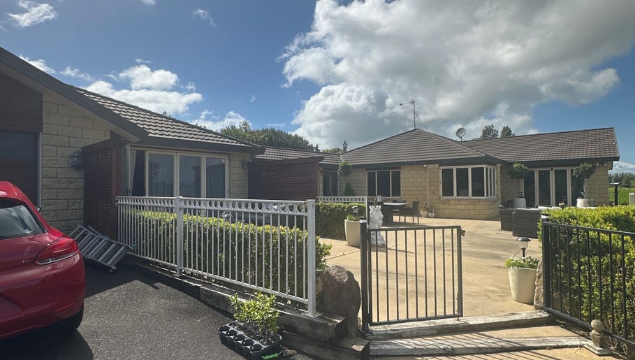 Modern facade of Lashed And Loaded, Horsham Downs, Waikato Region, NZ, featuring a welcoming outdoor area.