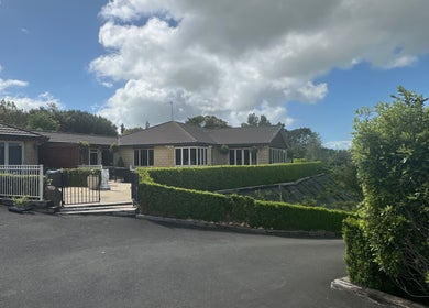 Exterior view of Lashed And Loaded venue in Horsham Downs, Waikato Region, NZ showing lush surroundings.