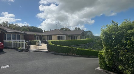 Exterior view of Lashed And Loaded venue in Horsham Downs, Waikato Region, NZ showing lush surroundings.