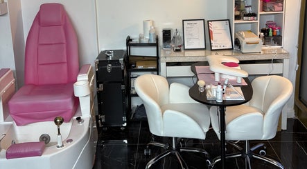 Stiletto Vault in Wembley, England, GB features luxe pink pedicure chairs and cozy manicure stations.