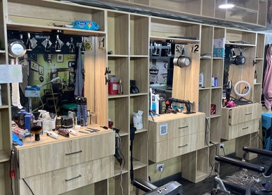 Interior of Lex Barber in Bogotá with stylish wooden stations and grooming tools.