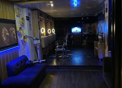 Interior of Lex Barber, Bogotá, Bogotá, CO, with illuminated mirrors and modern decor.