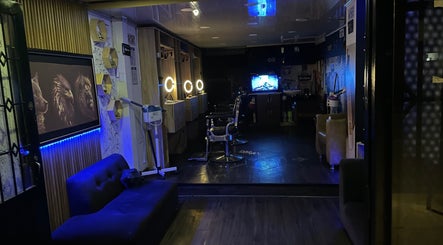 Interior of Lex Barber, Bogotá, Bogotá, CO, with illuminated mirrors and modern decor.