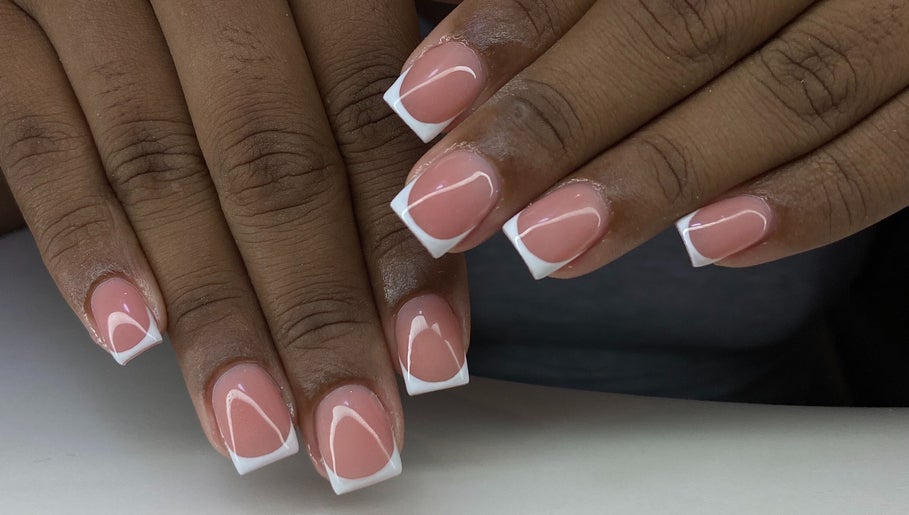 Elegant French manicure at Kshine Aesthetics, Willemstad, Curaçao, CW. Perfectly groomed hands with pink polish.