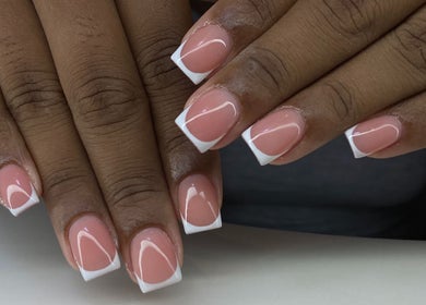 Elegant French manicure at Kshine Aesthetics, Willemstad, Curaçao, CW. Perfectly groomed hands with pink polish.