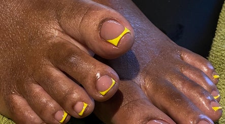 Bright yellow accented pedicure at Kshine Aesthetics in Willemstad, Curaçao, CW, showcasing nail artistry.