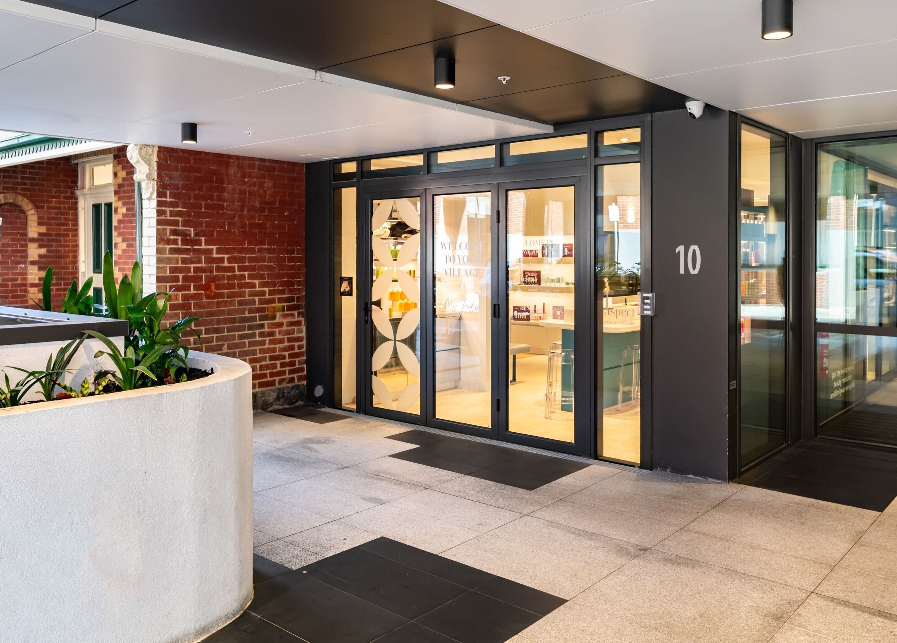 Front entrance of My Julie in Moonee Ponds, Victoria, AU with glass doors and modern decor.