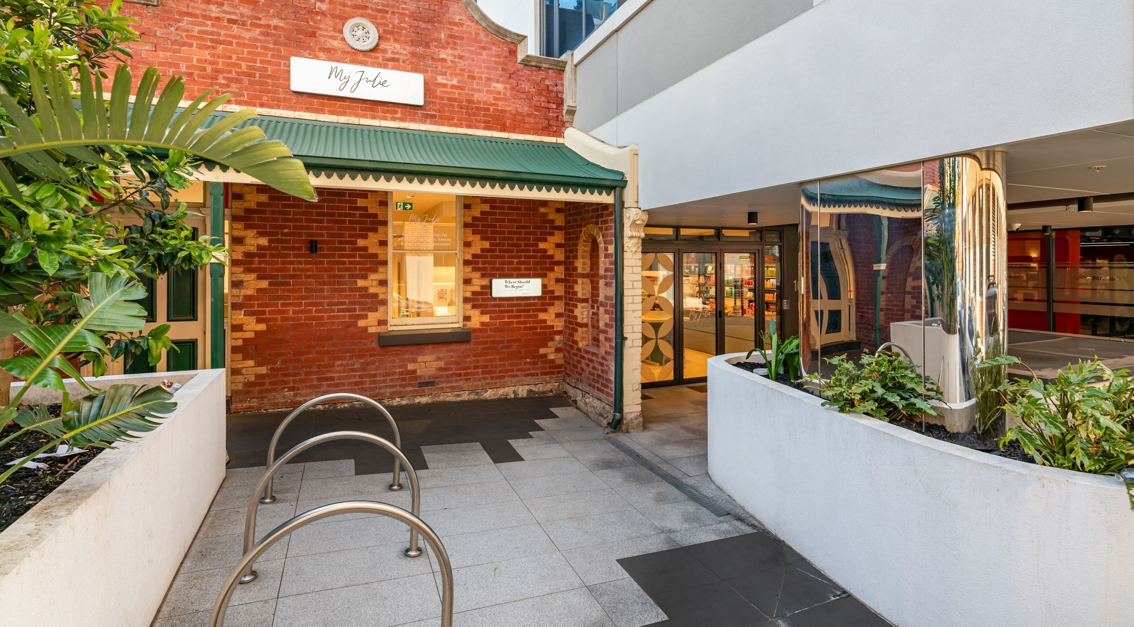 Entrance to My Julie in Moonee Ponds, Victoria, AU, showcasing vibrant brick walls and greenery.