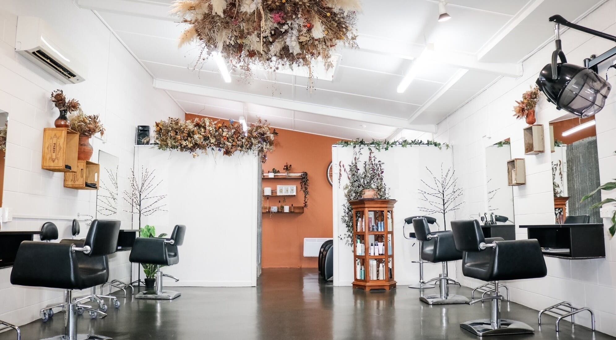 Interior of Clippers Hair Studio in Ashburton, Canterbury Region, NZ featuring stylish black salon chairs and decor.