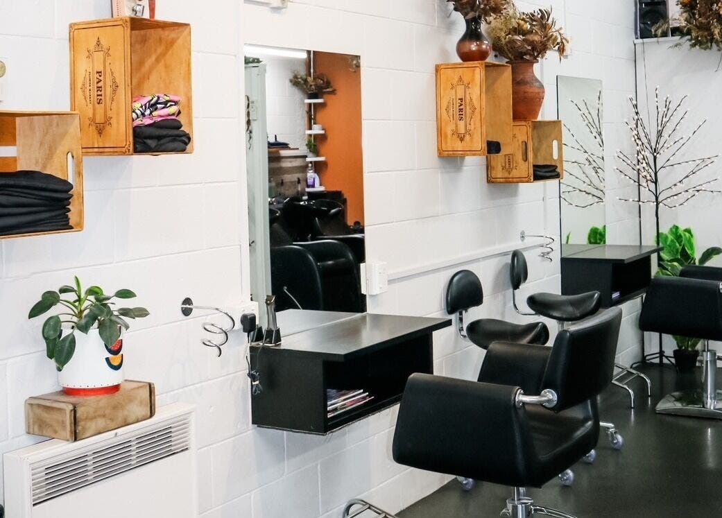 Interior of Clippers Hair Studio in Ashburton, Canterbury Region, NZ featuring stylish chairs and mirrors.
