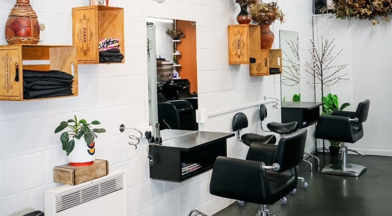 Interior of Clippers Hair Studio in Ashburton, Canterbury Region, NZ featuring stylish chairs and mirrors.
