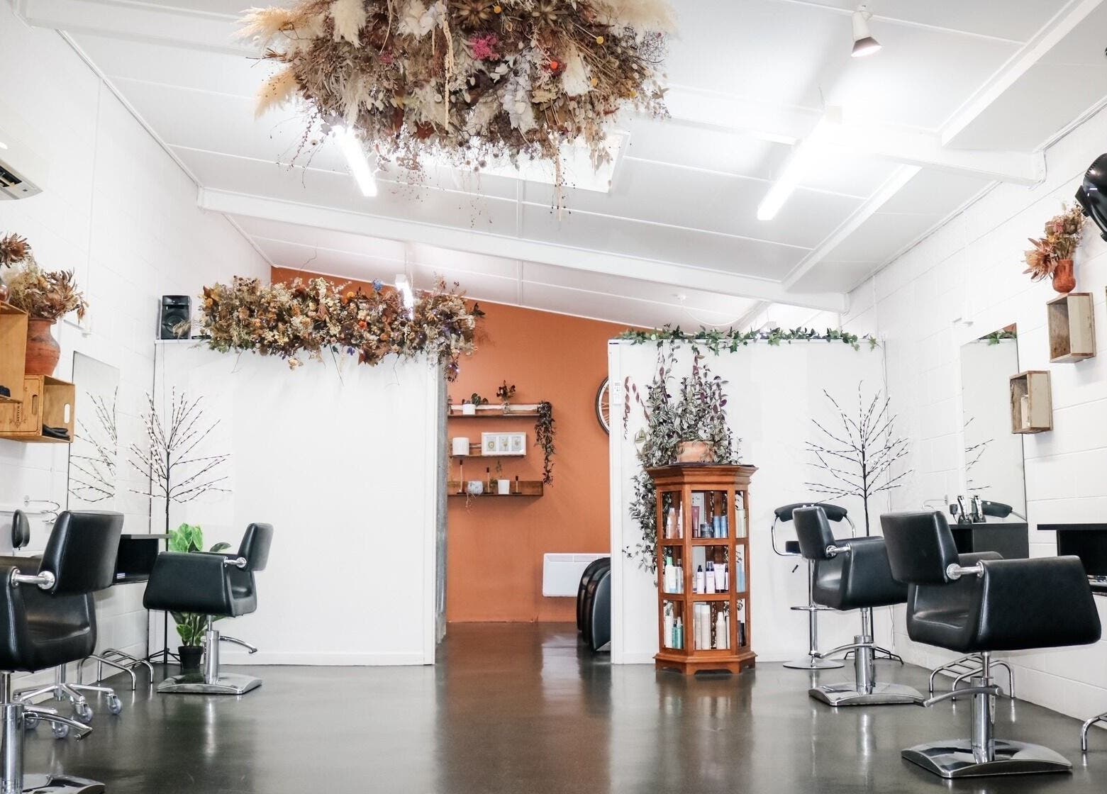 Elegant interior of Clippers Hair Studio in Ashburton, Canterbury Region, NZ with modern decor and styling chairs.