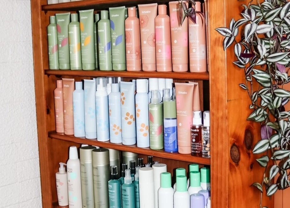A wooden shelf displaying hair products at Clippers Hair Studio, Ashburton, Canterbury Region, NZ.