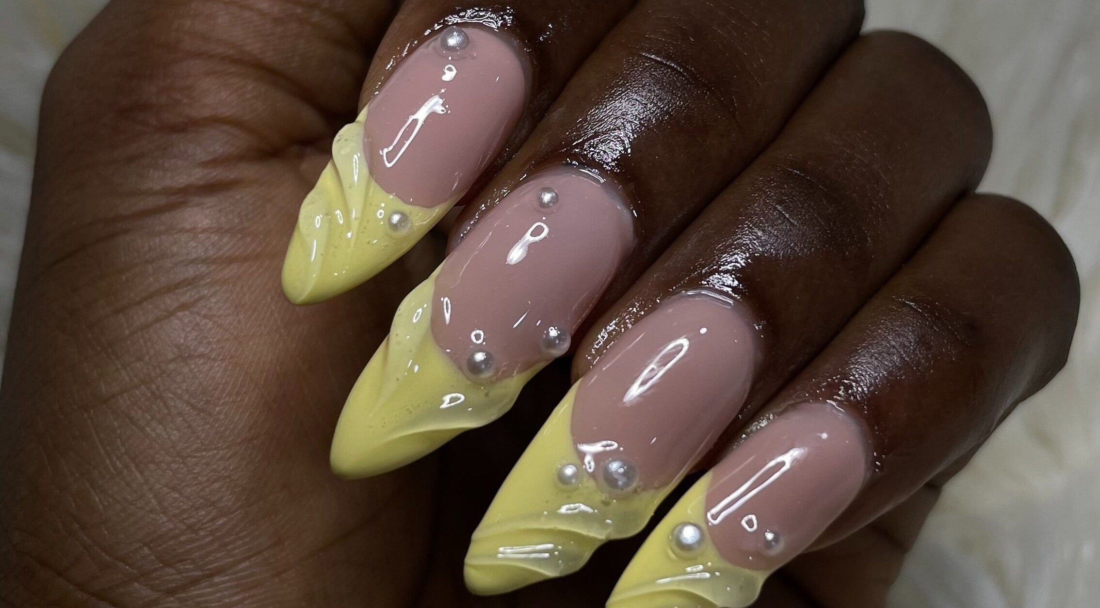 Elegant lemon and nude nails with pearl accents from Omosi Nails Studio, Lagos, Lagos, NG.