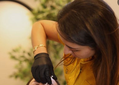 Dr Imen Azabou in Montréal, Québec, CA, performs a beauty treatment with care and precision.