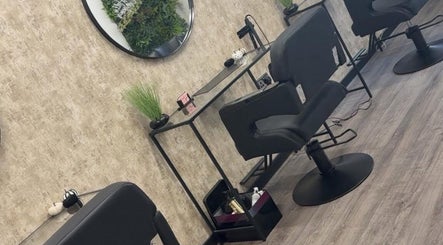 Modern salon station at Hair by HRL in Dundee, Scotland, GB, featuring sleek chairs and calming decor.