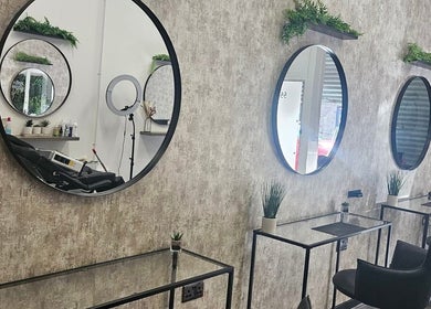 Modern salon interior at Hair by HRL, Dundee, Scotland, GB, with sleek mirrors and stylish decor.