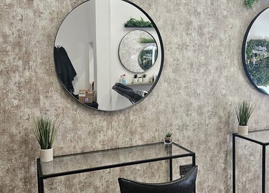 Modern salon interior at Hair by HRL, Dundee, Scotland, GB with mirrors and plants.