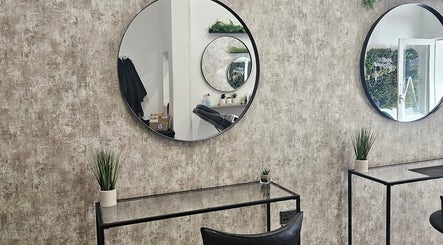 Modern salon interior at Hair by HRL, Dundee, Scotland, GB with mirrors and plants.