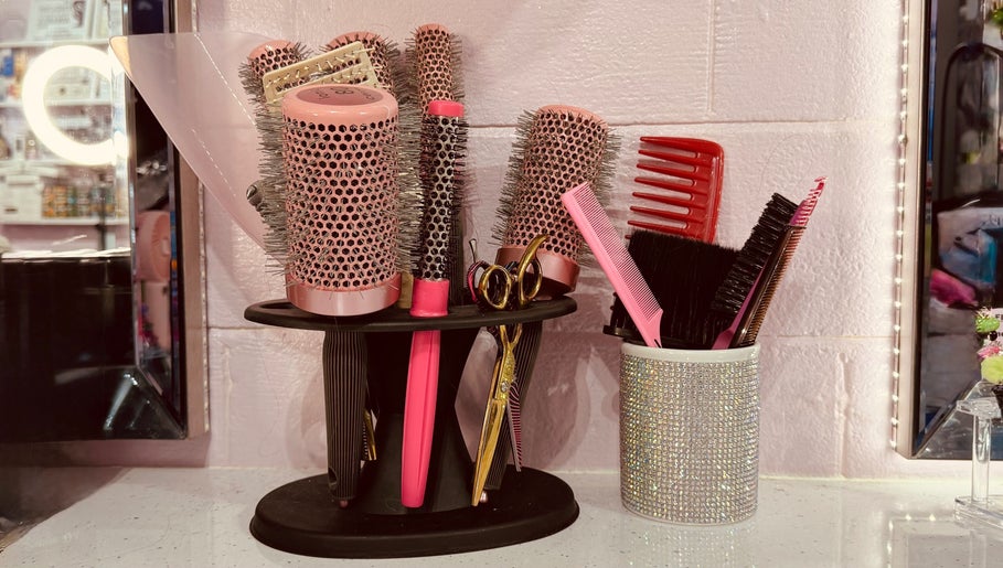 Hair styling tools at ShanayaOakes.hair in Bath, England, GB. Brushes, combs, and scissors in a chic setup.