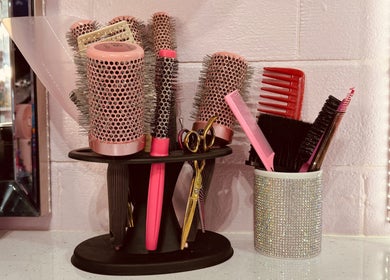 Hair styling tools at ShanayaOakes.hair in Bath, England, GB. Brushes, combs, and scissors in a chic setup.