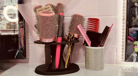 Hair styling tools at ShanayaOakes.hair in Bath, England, GB. Brushes, combs, and scissors in a chic setup.
