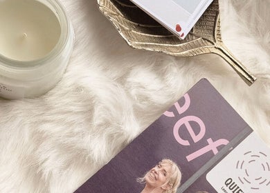 Elegant decor at BARE AIMÉ, Leeuwarden, Friesland, NL, featuring a candle on a soft fur surface.