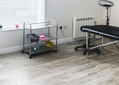 A serene treatment room at The Brow Rehab, Little Lever, England, GB featuring a massage table and minimalist decor.