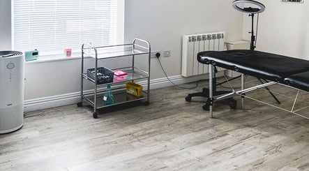 A serene treatment room at The Brow Rehab, Little Lever, England, GB featuring a massage table and minimalist decor.