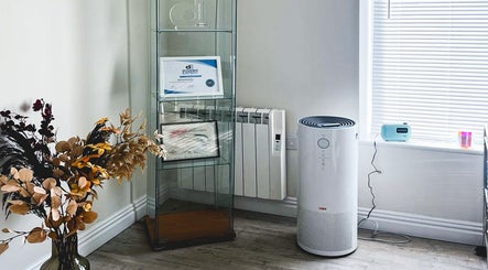 Elegant corner decor at The Brow Rehab, Little Lever, England, GB, featuring certificates and a modern purifier.