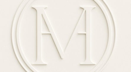 Embossed logo of Maison De Hannah, Norwest, New South Wales, AU, showcasing an elegant 'M' symbol.