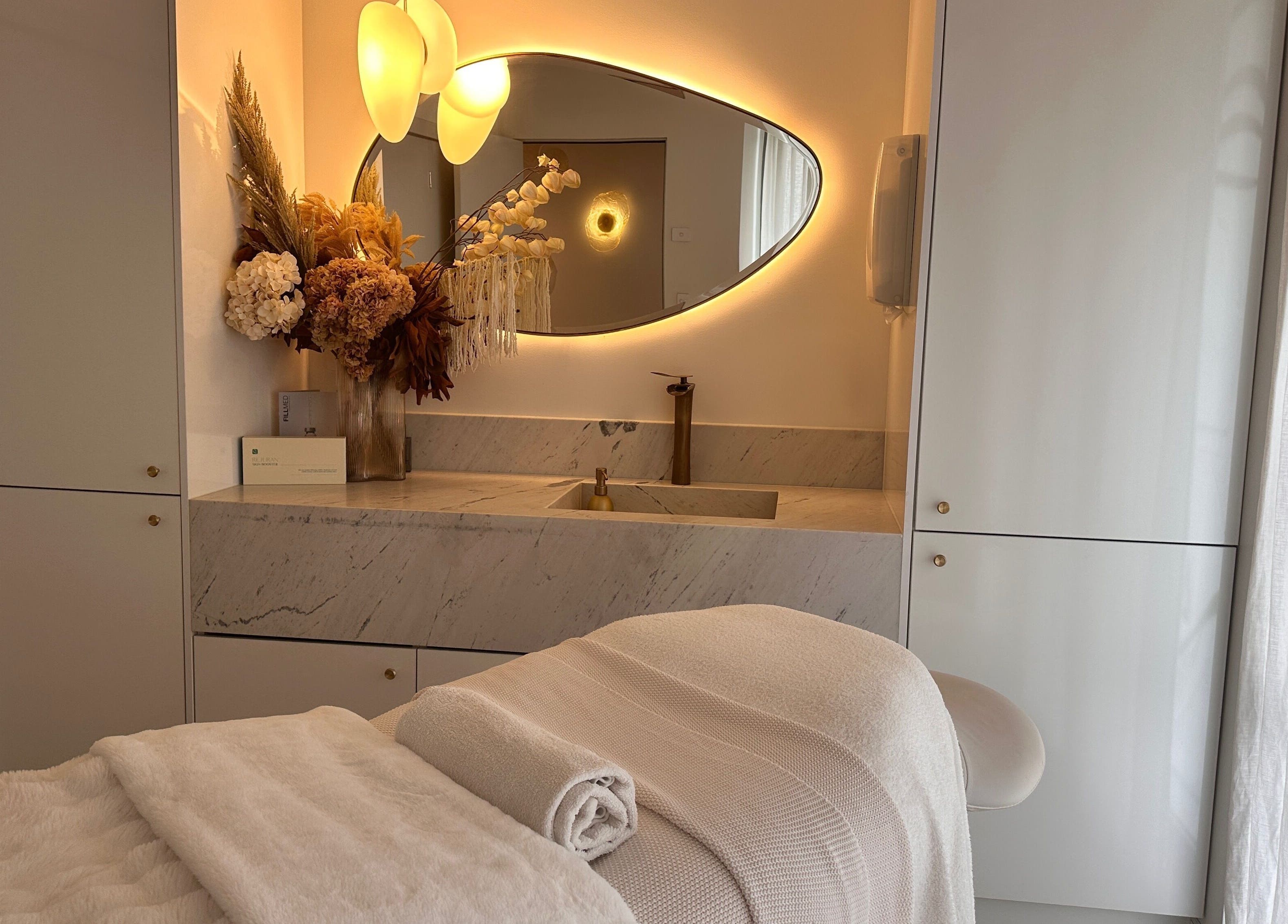 Elegant spa room at Maison De Hannah in Sylvania Waters, New South Wales, AU with ambient lighting and floral decor.