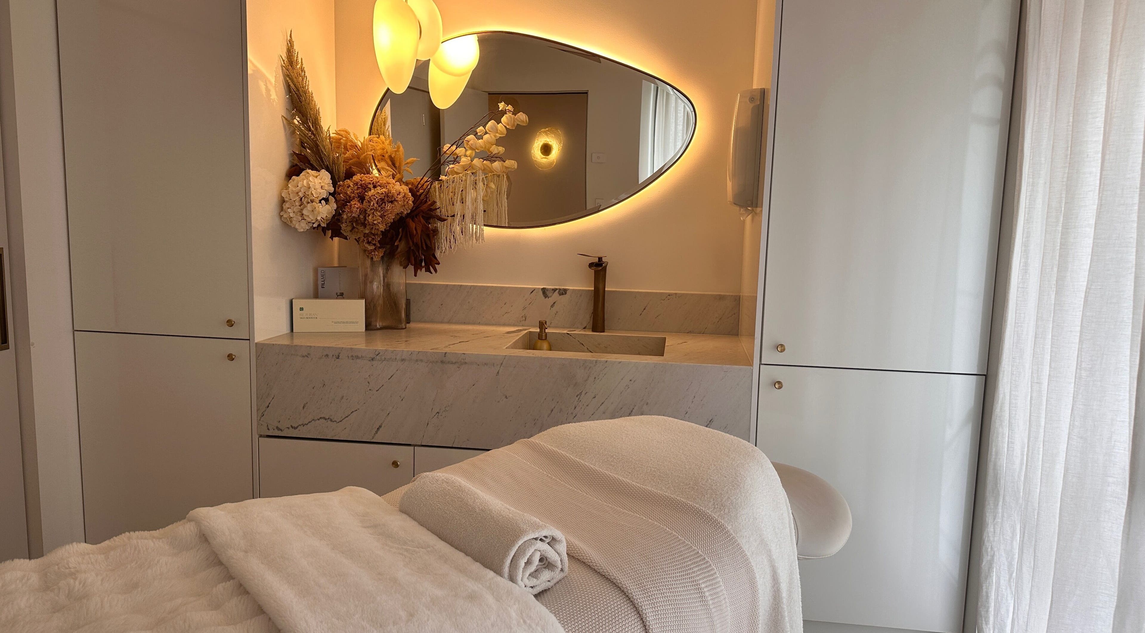 Elegant spa room at Maison De Hannah in Sylvania Waters, New South Wales, AU with ambient lighting and floral decor.