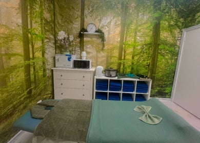 Relaxing massage room at Reborn Massage by Dwi, Cooloongup, Western Australia with forest-themed decor.