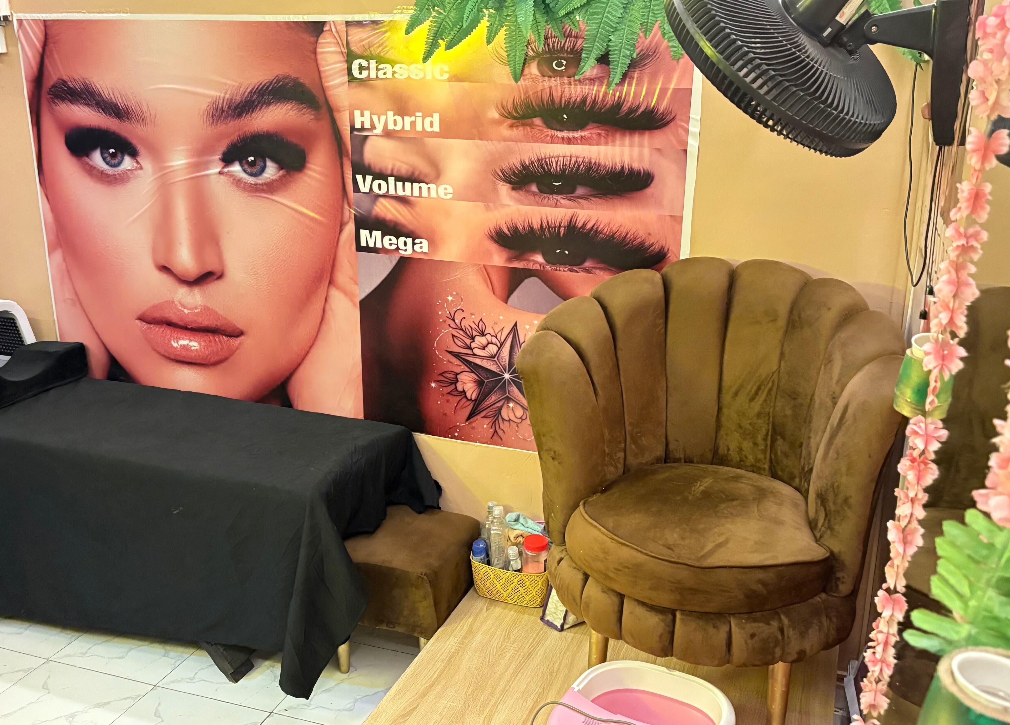 Cozy seating at Nailed by Ronnie, Ikeja, Lagos, NG, with lash styles displayed on the wall.