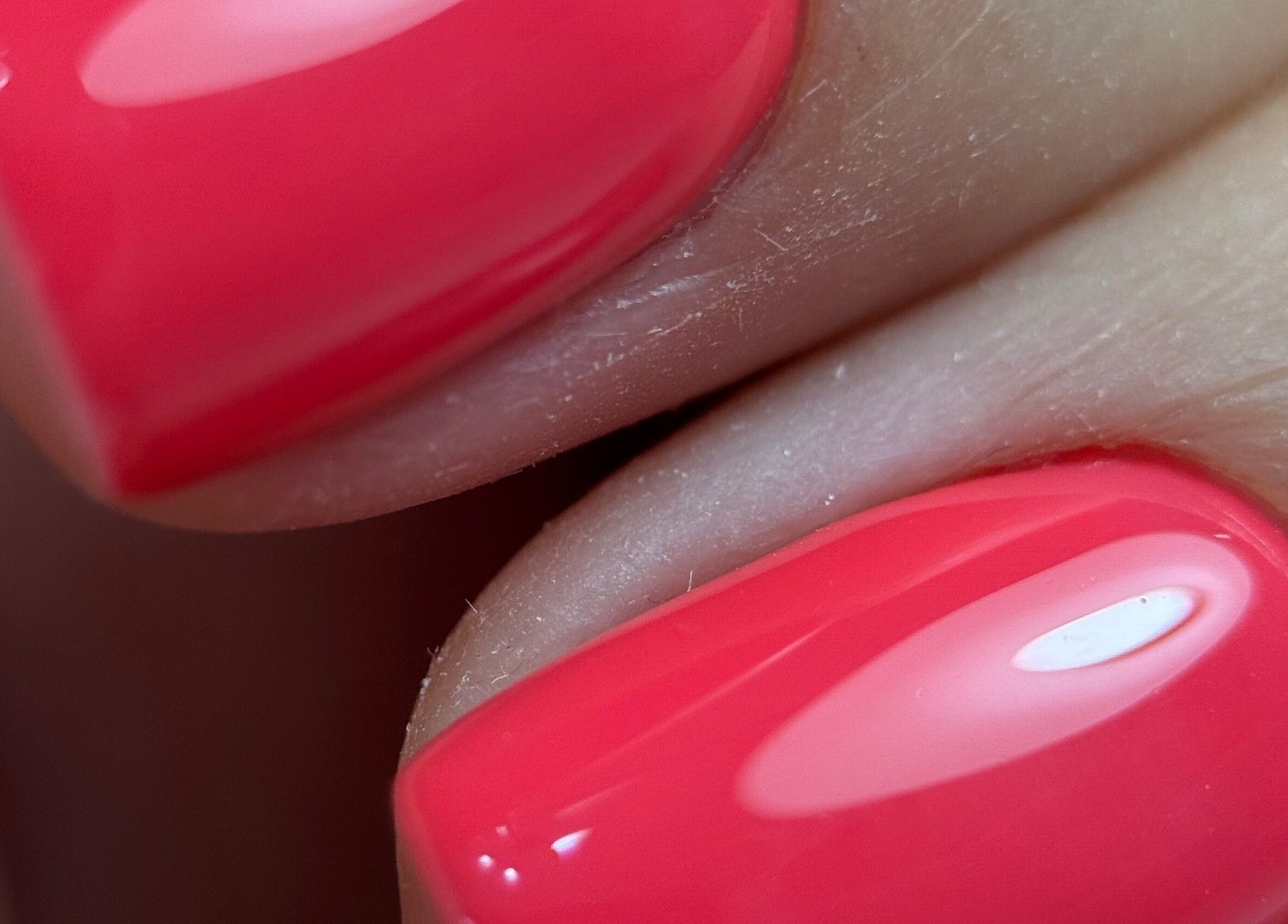 Glossy red manicure at Touch of Elegance in Colchester, England, GB, showcasing nail art precision.