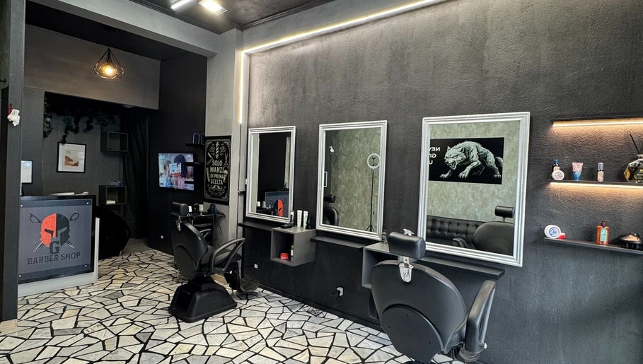 Elegante interno di G barber shop a Roma, Lazio, IT con specchi e sedie moderne.