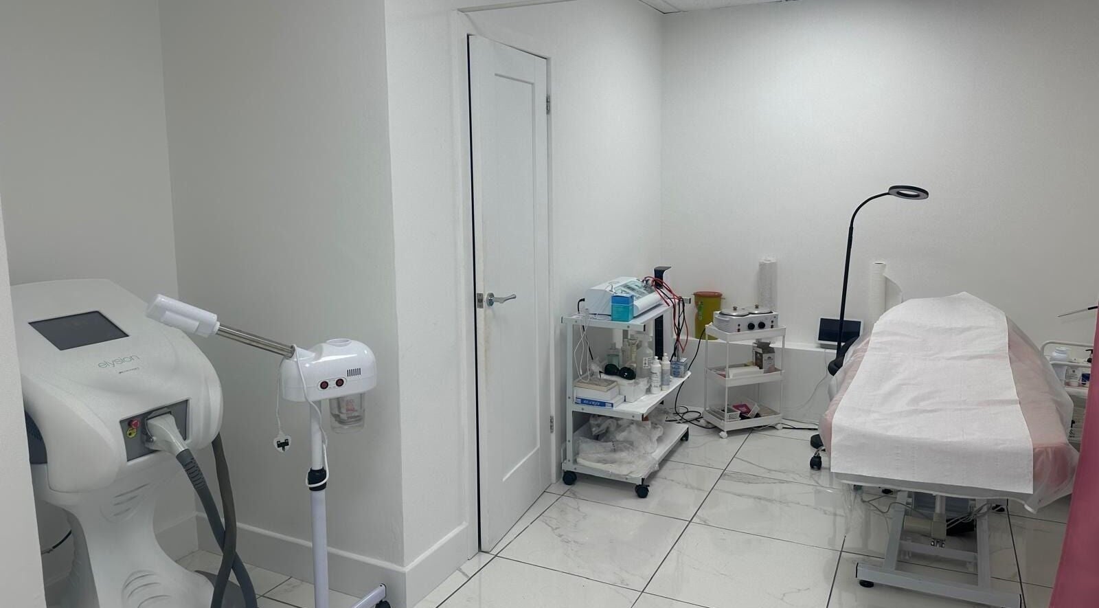 Treatment room at Aesthetic Beauty Clinic, Kingston Upon Thames, England, GB, equipped with modern wellness devices.